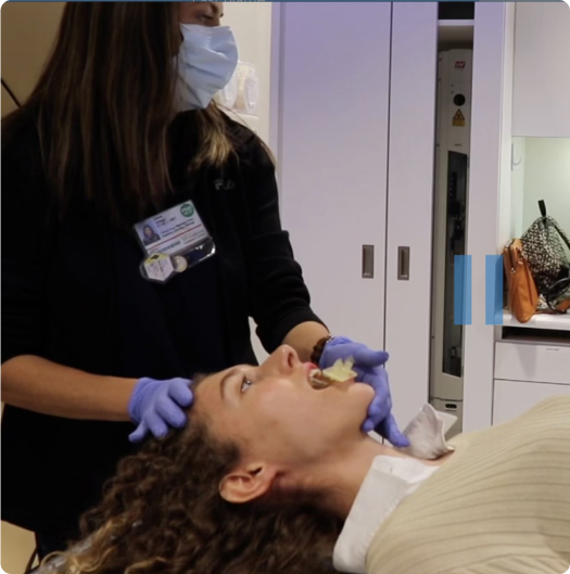 A doctor positioning Stentra in a patient mouth before starting radiation